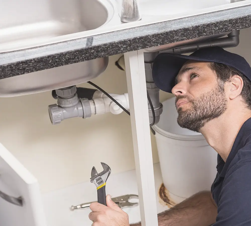 A Blackdown Heating Ltd engineer working on a plumbing repair