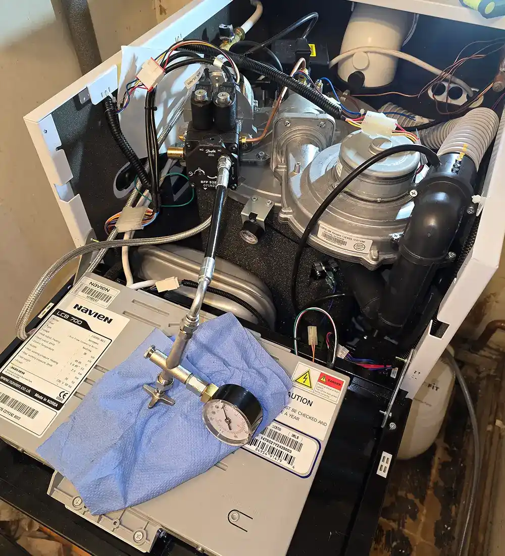 A Blackdown Heating Ltd engineer servicing a boiler